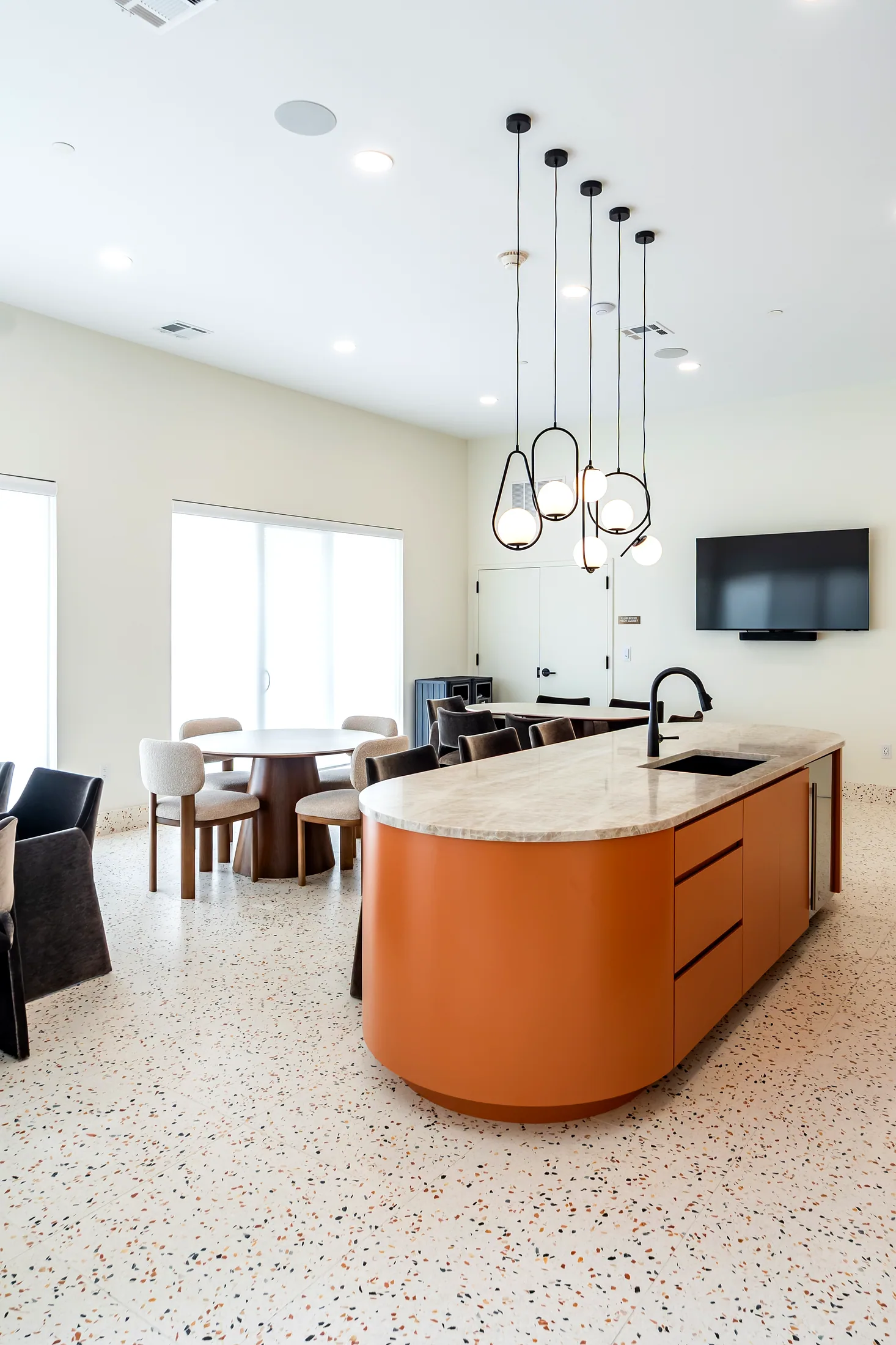 Club room kitchen island at Five85West with a terrazzo floor